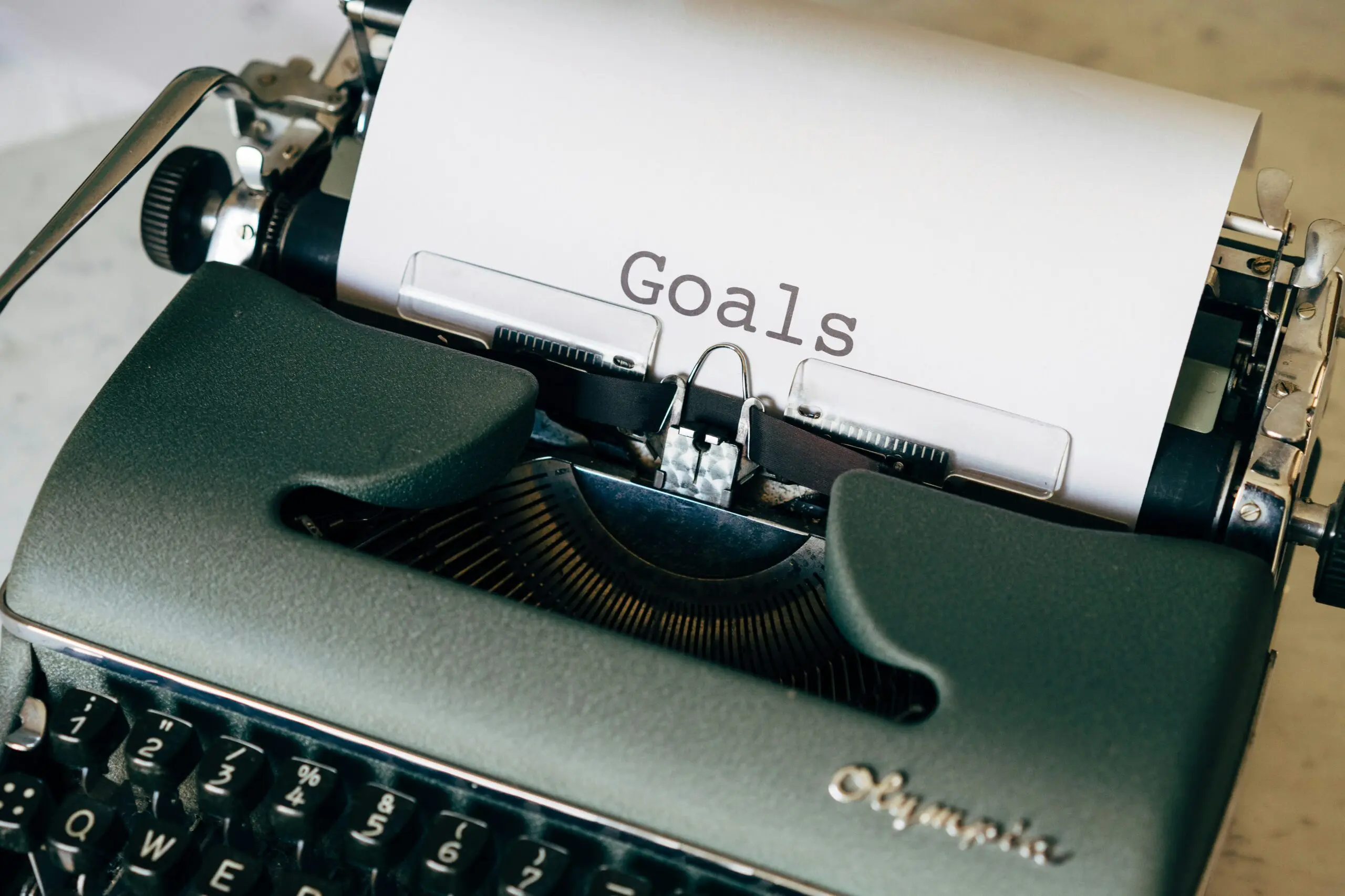 markus-winkler-LNzuOK1GxRU-unsplash Typewriter with a page set up and the word "Goals" written on it