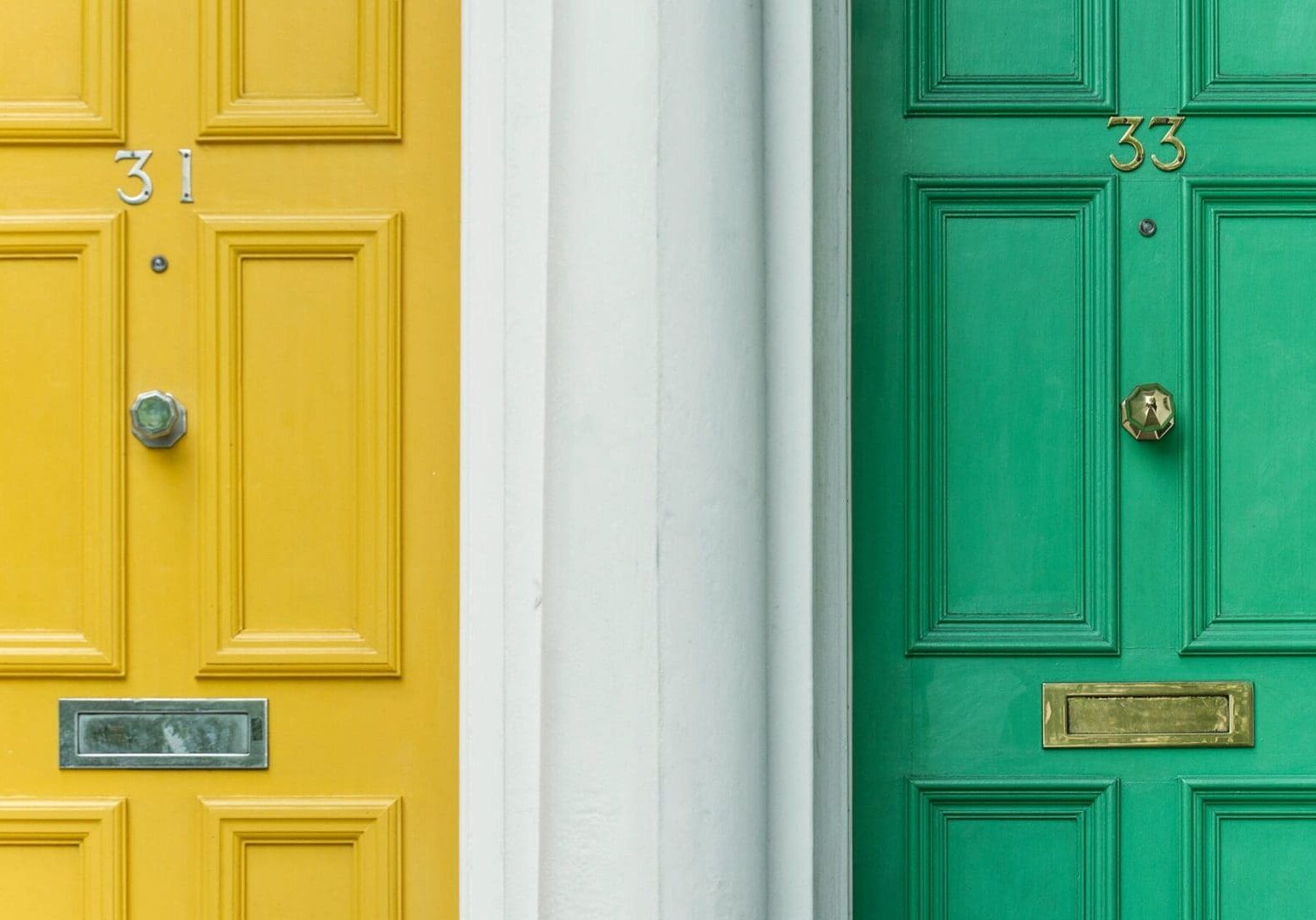 Two neighboring houses with a yellow door and a green door, symbolizing different investment strategies and financial paths.