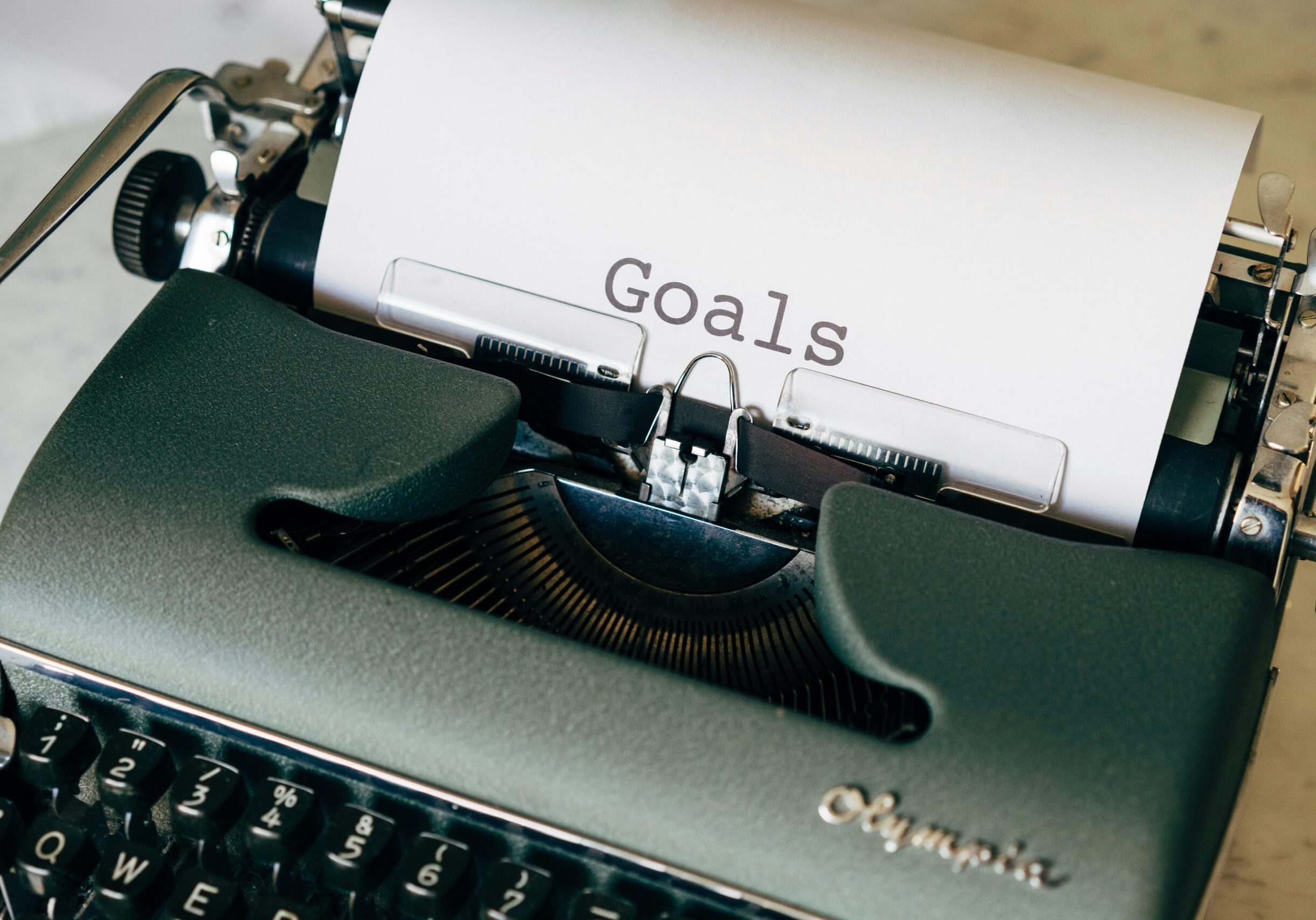 markus-winkler-LNzuOK1GxRU-unsplash Typewriter with a page set up and the word "Goals" written on it